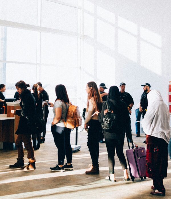 Traveler with luggage waiting at airport during international travel process
