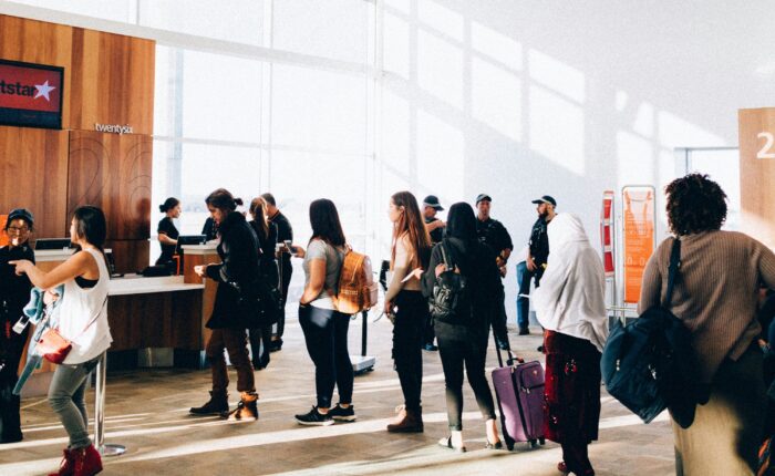 Traveler with luggage waiting at airport during international travel process