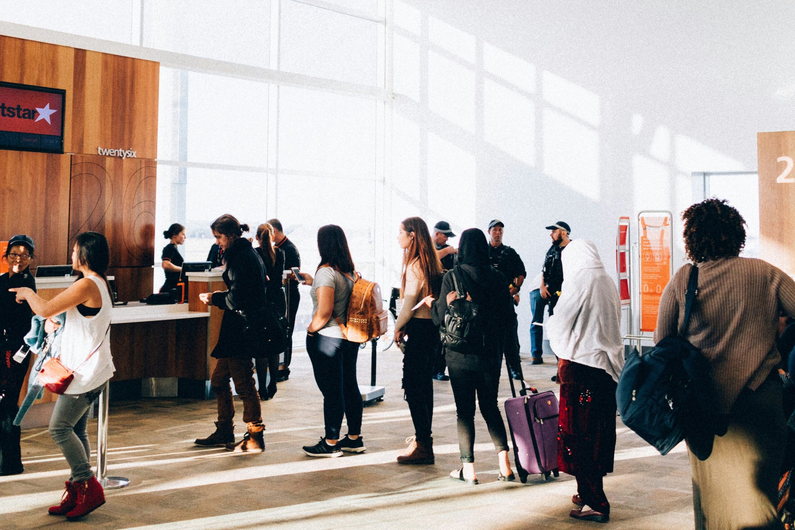 Traveler with luggage waiting at airport during international travel process