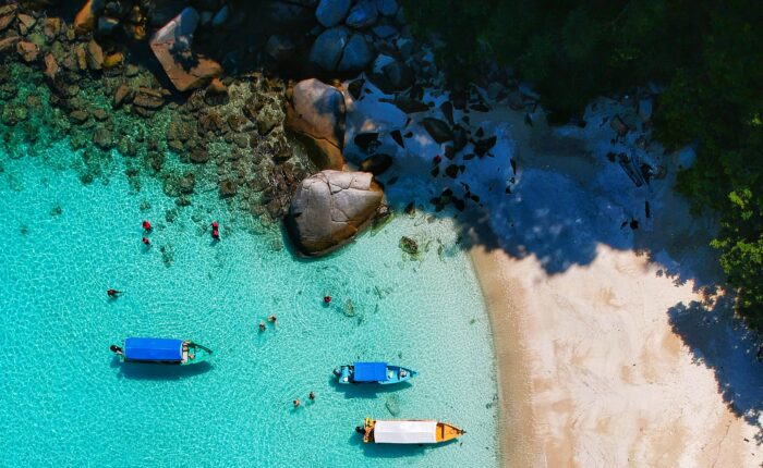Malaysia island destination with boats and clear blue water