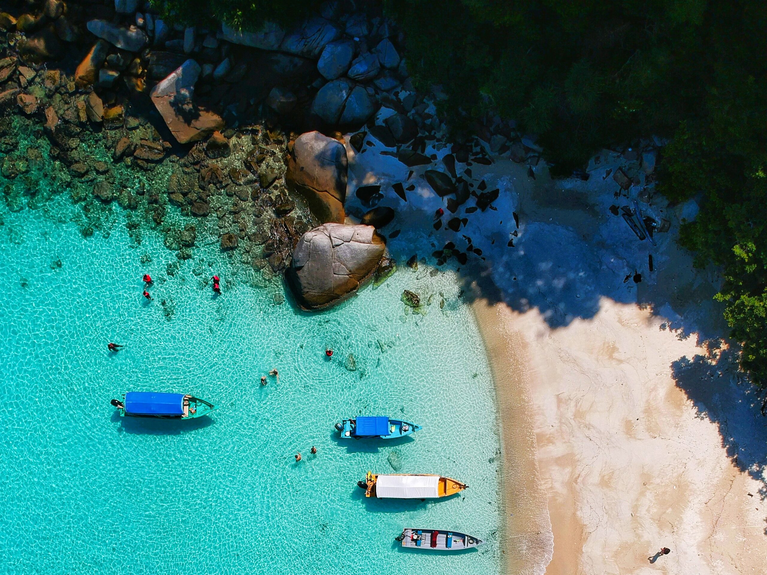 Malaysia island destination with boats and clear blue water