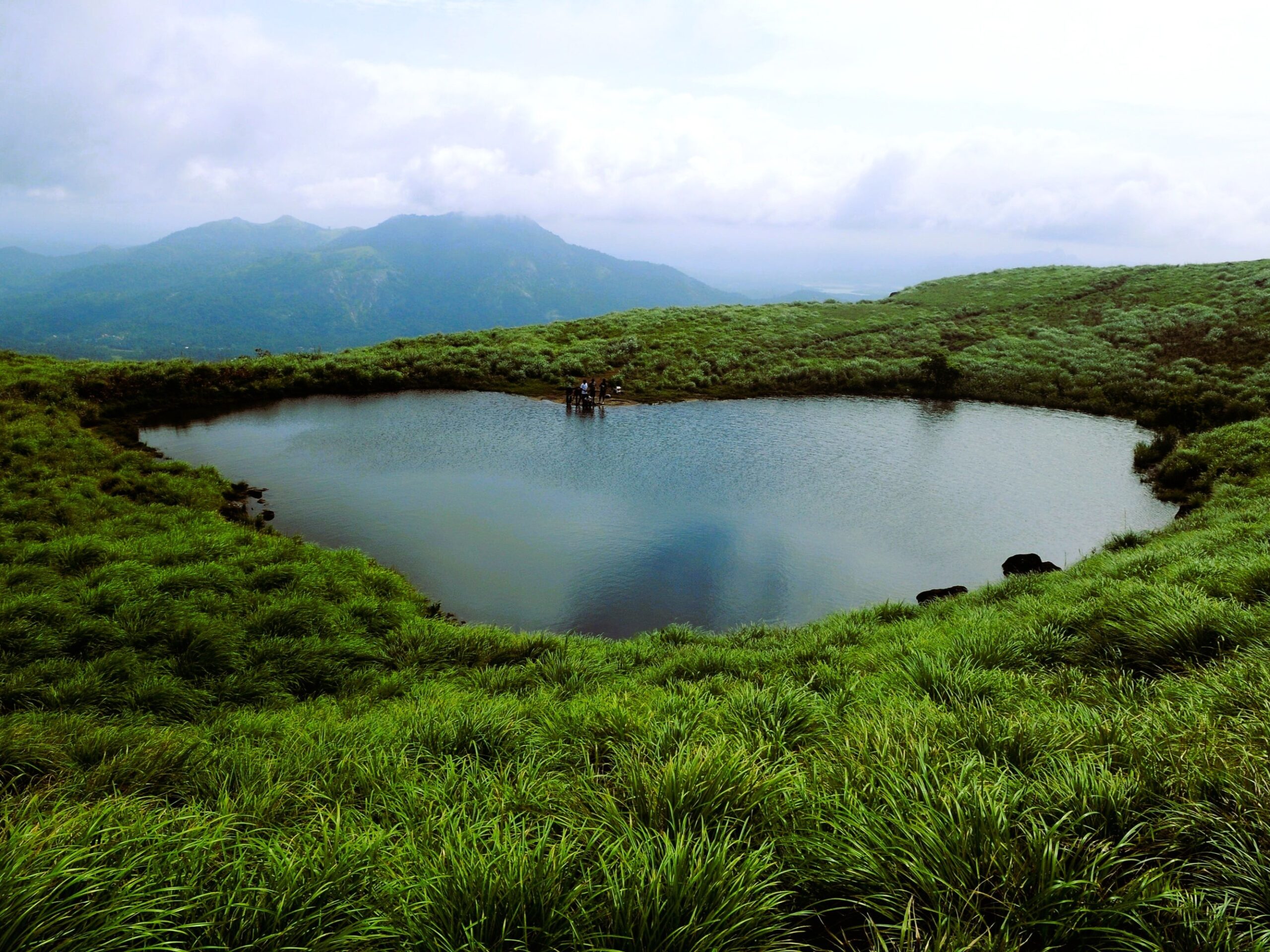 Wayanad India getaway package featuring Chembra Peak, lush hills, and scenic landscapes