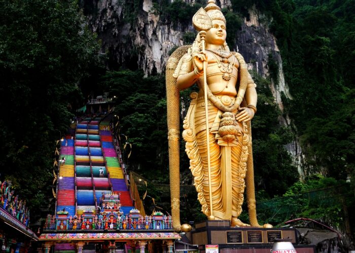Golden Lord Murugan statue and colourful staircase at Batu Caves, Malaysia