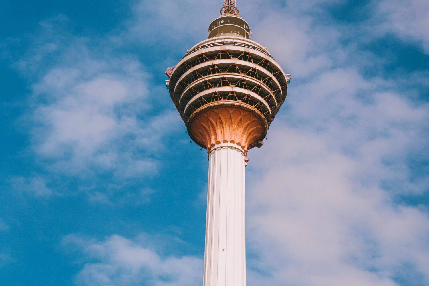 KL Tower against a blue sky in Kuala Lumpur, Malaysia featured in Malaysia Tour Package