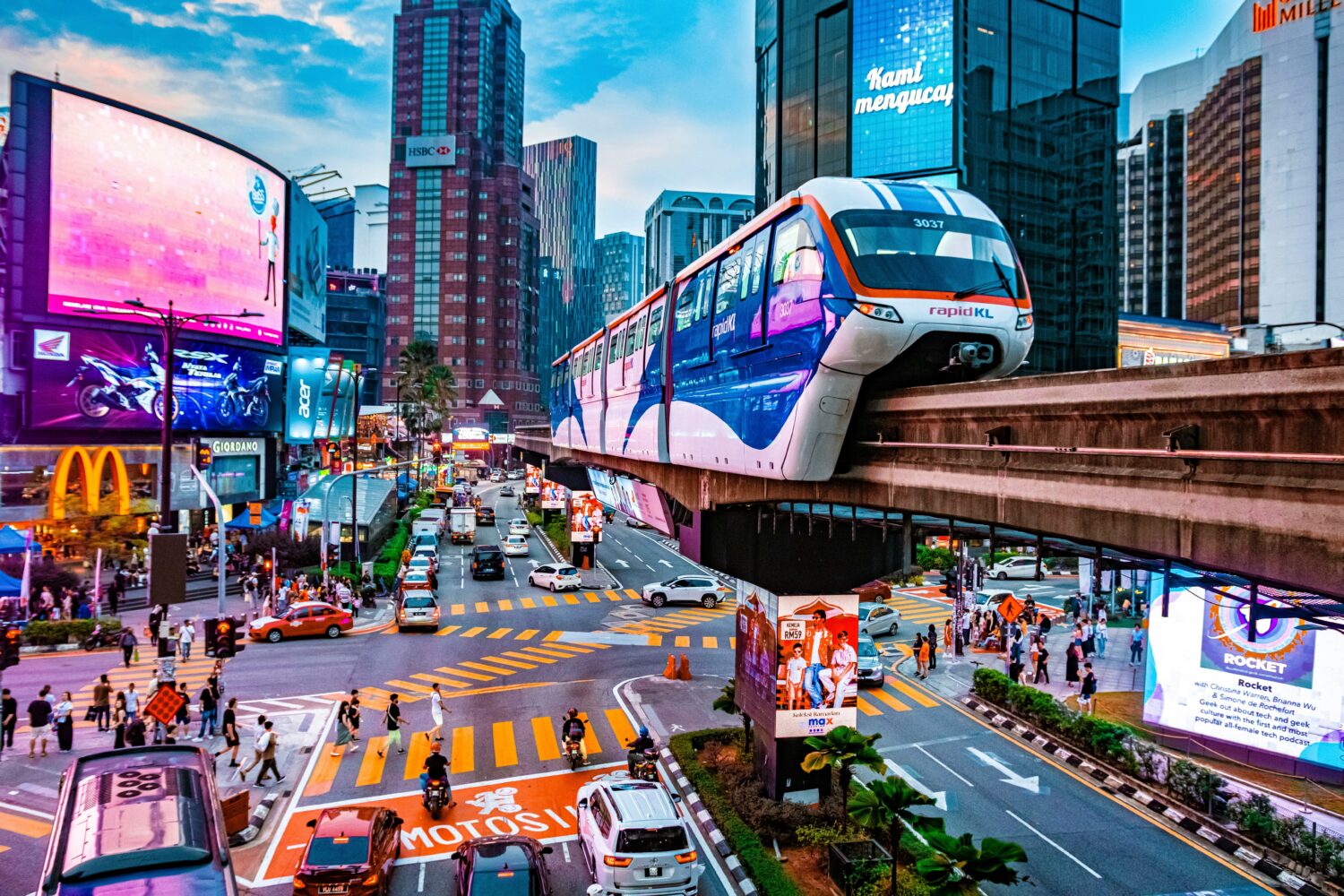 Busy Kuala Lumpur city centre with elevated train and modern buildings