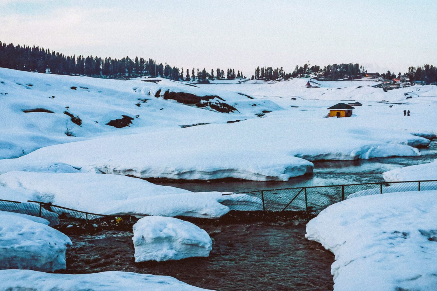 Snow-covered landscape and flowing stream near Thajwas Glacier in Sonamarg