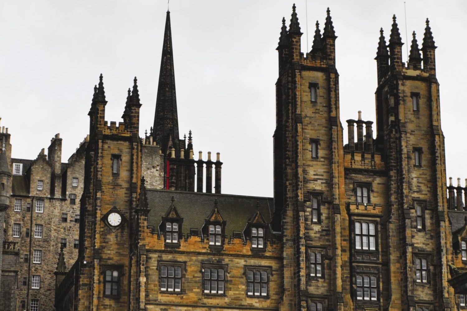 Edinburgh red tour bus passing featured in Scotland 8 Nights 9 Days Tour